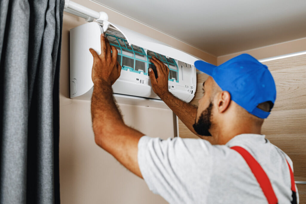 AC Repair in Jackson, WY 1 A technician is servicing an air conditioner